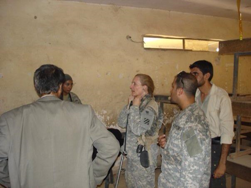 Terri working on a critically ill Iraqi woman while communicating through an interpreter.